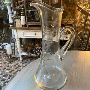 Vintage wine pitcher with etched grapes